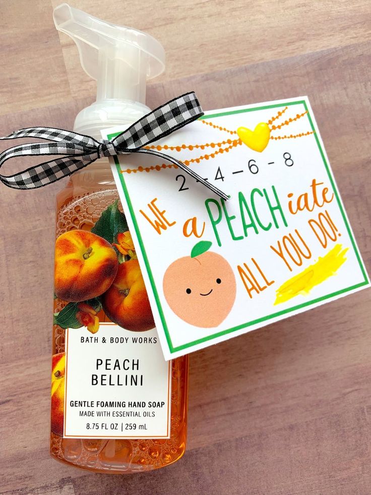 a bottle of peach all you do hand sanitizer with a tag on it