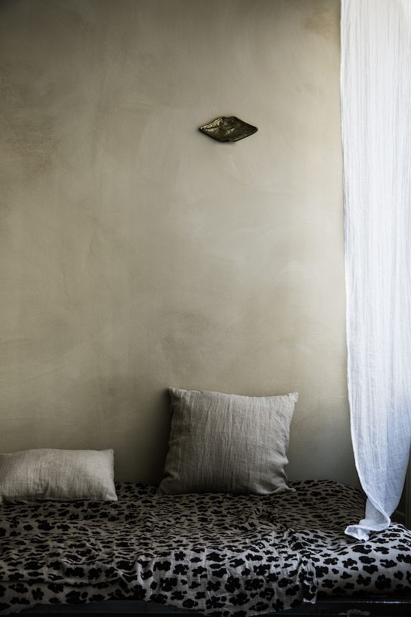 a leopard print bed with white curtains and pillows