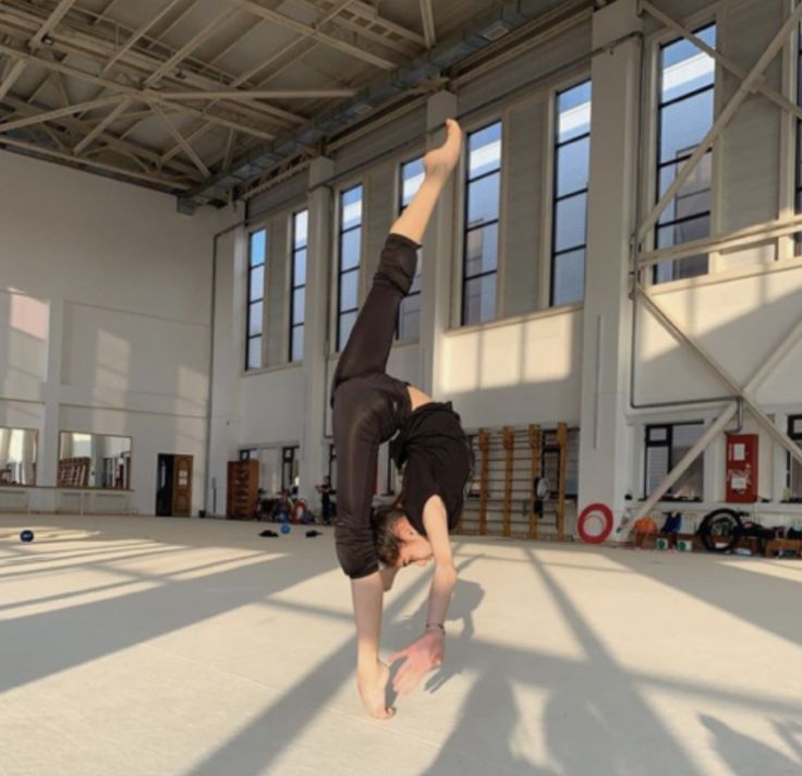 a person doing a handstand in an empty building