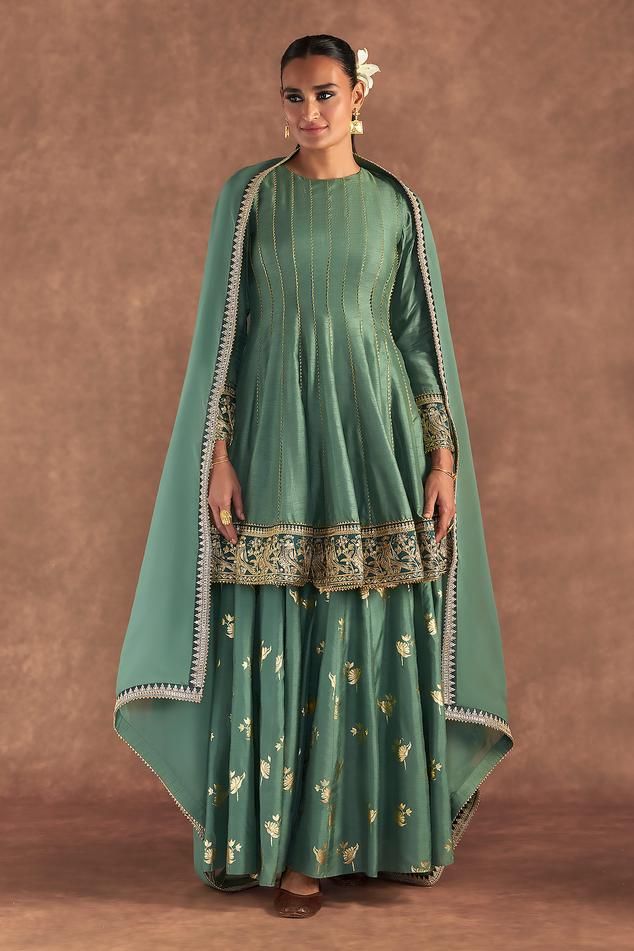 Moss green anarkali edged with kinari and embellished with border. Comes with irisbud foil printed sharara edged with kinari and a printed dupatta.
Components: 3
Pattern: Foil Printed, Embroidered
Type Of Work: Irisbud
Neckline: Round
Sleeve Type: Full
Fabric: Anarkali and Sharara- Raw Silk, Dupatta- Organza
Color: Green
Other Details: 
Disclaimer: The actual print-placement and colour of the product may vary slightly from the image shown.
Occasion: Sangeet - Aza Fashions Luxury Raw Silk Anarkali Sharara, Luxury Anarkali Slub Silk Sharara, Luxury Green Cotton Silk Sharara, Luxury Green Sharara With Bandhani Print, Designer Green Raw Silk Anarkali Set, Green Raw Silk Anarkali Set For Designer Wear, Green Cutdana Raw Silk Anarkali Set, Green Semi-stitched Raw Silk Anarkali Set, Green Anarkali Salwar Kameez In Raw Silk