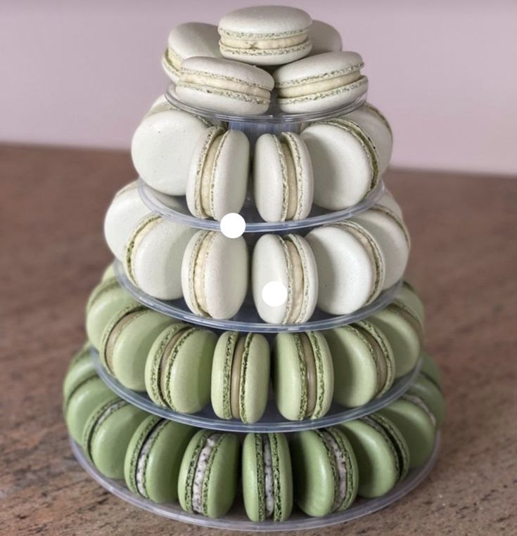 a stack of green and white macaroons sitting on top of eachother