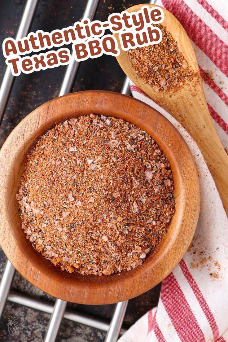 a wooden bowl filled with spices next to a wooden spoon on top of a red and white towel