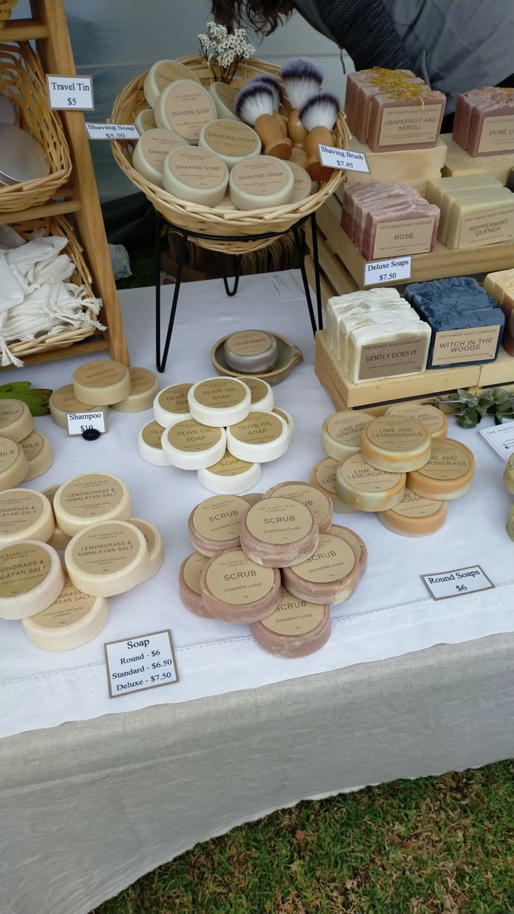 a table topped with lots of different types of soaps