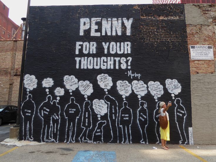 a woman standing in front of a wall with writing on it that says penny for your thoughts