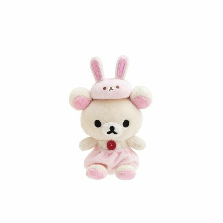 a small white stuffed animal with pink ears on it's head, sitting in front of a white background