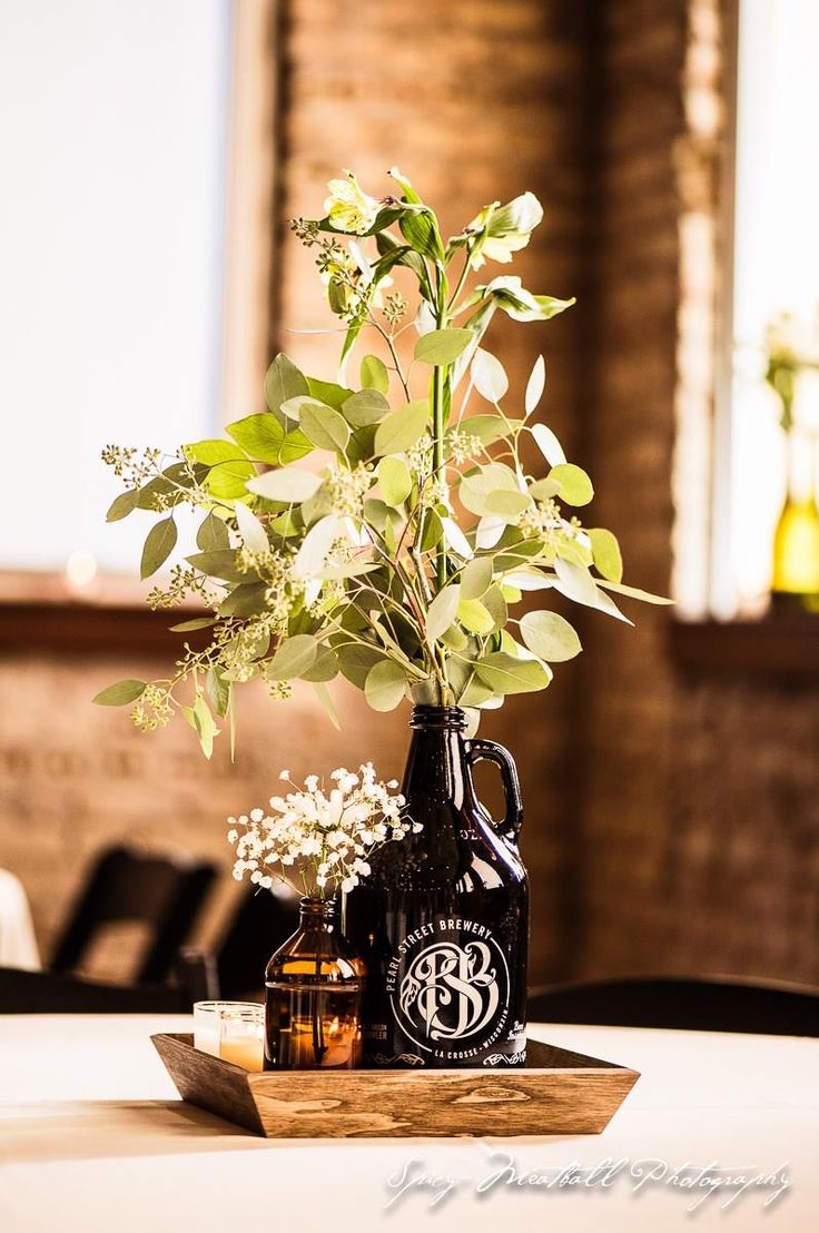 a vase with some flowers in it sitting on a table