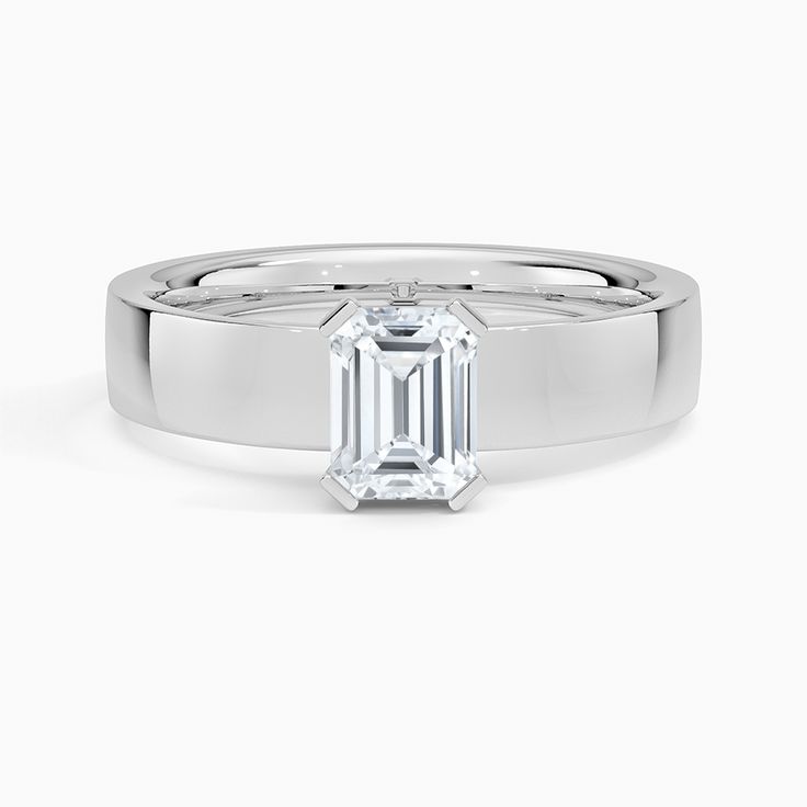 Emerald Cut Parker Solitaire Engagement Ring - Platinum. This modern engagement ring features a thick band that makes an eye-catching statement. An open gallery allows light to reach the paddle prong-set center stone, maximizing brilliance and sparkle. Modern Emerald Ring With Vvs Clarity And Baguette Cut, Modern Emerald Ring Vvs Clarity For Wedding, Modern Emerald Ring In White Gold With Prong Setting, Modern Solitaire Emerald Ring With Round Cut, Modern White Gold Emerald Ring With Prong Setting, Modern Emerald Ring With Vvs Clarity For Wedding, Modern Emerald Ring With Brilliant Cut For Anniversary, Modern Emerald Ring With Round Band For Anniversary, Modern Solitaire Emerald Promise Ring