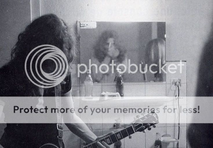 a woman playing an electric guitar in front of a mirror with the caption protect more of your memories for less