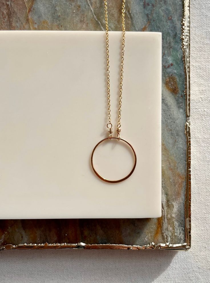 The simple circle necklace can be worn on its own or layered with your favorite pieces. Available in both sterling silver and 14k gold fill. The circle pendant measures approximately 1 inch or 20mm in diameter.  This piece coordinates well with so many other pieces in my shop! Minimalist Circle Charm Gold Necklace, Gold Circle Minimalist Charm Necklace, Minimalist Gold Circle Charm Necklace, Everyday Yellow Gold Circle Charm Necklace, Everyday Rose Gold Round Pendant Necklace, Circle Jewelry With Adjustable Chain For Everyday, Dainty Everyday Round Necklaces, Rose Gold Round Disc Necklace For Everyday, Rose Gold Hypoallergenic Round Charm Necklace