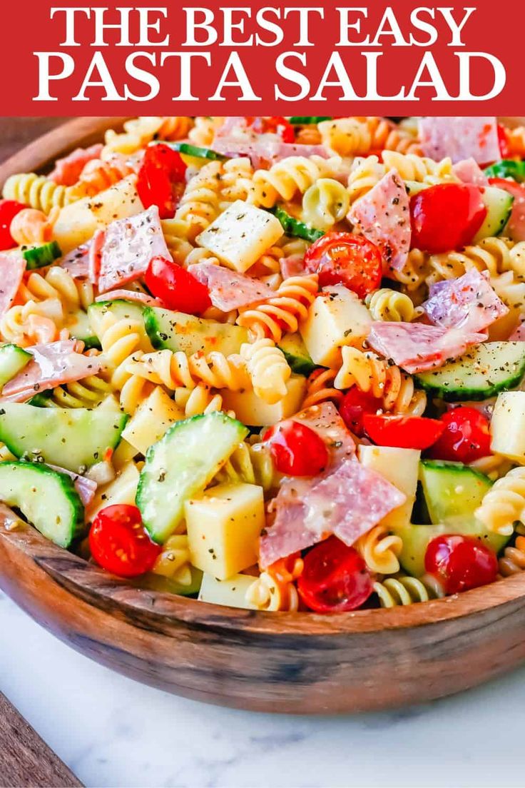 the best pasta salad is in a wooden bowl