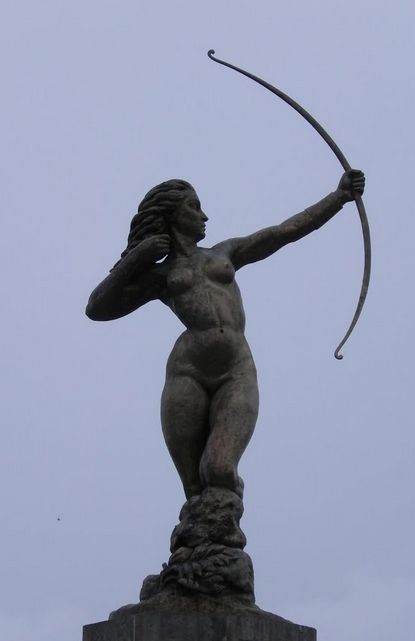 the statue is holding a bow and arrow