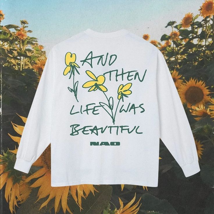 a white t - shirt that says and then life was beautiful surrounded by sunflowers