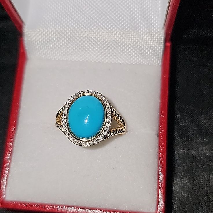 Oval Turquoise And 1/10 Ct. T.W Diamond Frame Rope-Textured Split Shank Ring In 14kt Gold. Size 7.5 Formal Blue Turquoise Ring With Accent Stones, Elegant Turquoise Ring With Stone Setting, Oval Turquoise Ring With Diamond Accents, Turquoise Ring With Diamond Accents As Gift, Elegant Turquoise Ring With Diamond Accents As Gift, Gift Turquoise Ring With Diamond Accents, Formal Blue Oval Turquoise Ring, Oval Blue Turquoise Ring In Fine Jewelry Style, Oval Blue Turquoise Ring Fine Jewelry