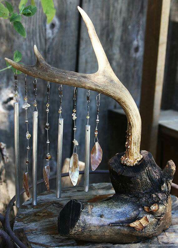 a piece of wood that has some kind of jewelry hanging from it's side