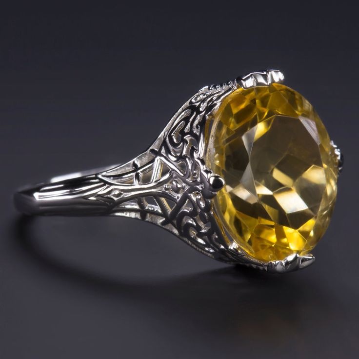 This beautiful and unique solitaire ring features a 4.75ct oval cut citrine set in a classically elegant vintage style design that will never go out of style! Measuring approximately 12mm across, the citrine has a substantial look and a gorgeous sunny yellow hue. Utterly classic and romantic, the antique style setting is richly textured with intricate engraving and graceful filigree. The effect is chic but also dreamy and softly feminine, a perfect choice for a timeless gift or a treat for yours Luxury Yellow Oval Rings, Oval Topaz Ring With Center Stone For Formal Occasions, Luxury Oval Topaz Ring For Formal Occasions, Elegant Polished Topaz Ring For Formal Occasions, Elegant Yellow Oval Cabochon Ring, Fine Jewelry Yellow Oval Topaz Ring, Antique Oval Gemstone Rings, Luxury Yellow Rings For Collectors, Yellow Oval Topaz Ring With Polished Finish