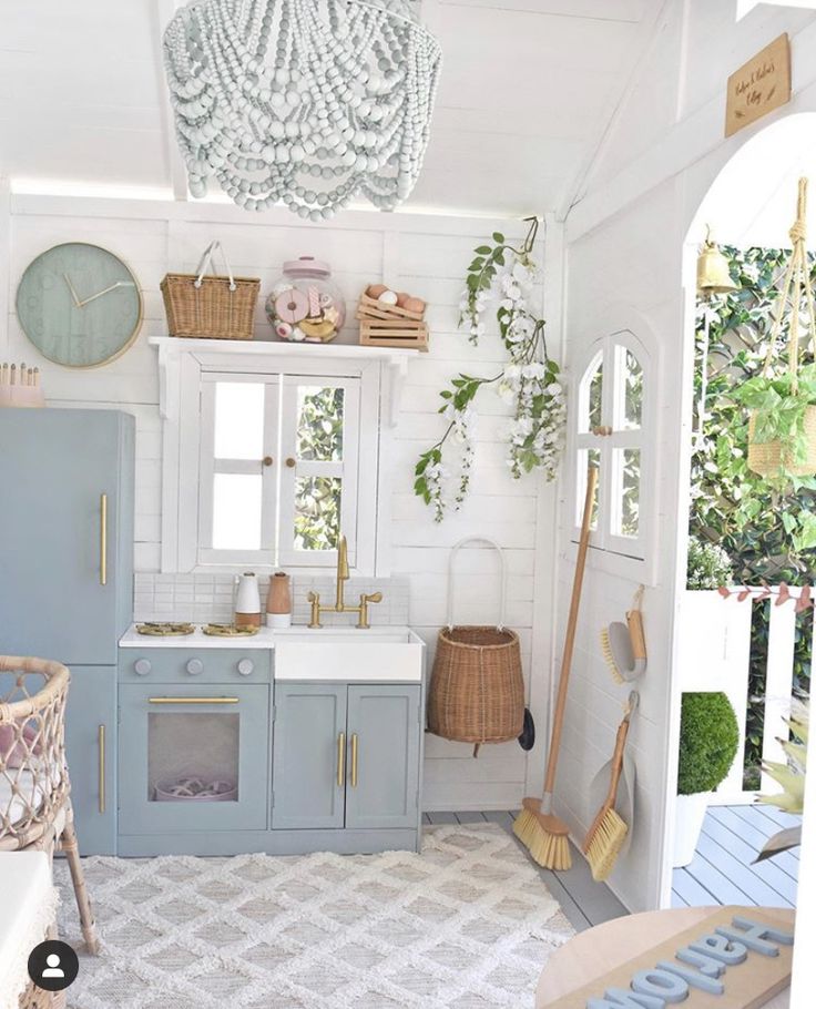 a kitchen with blue cabinets and white walls