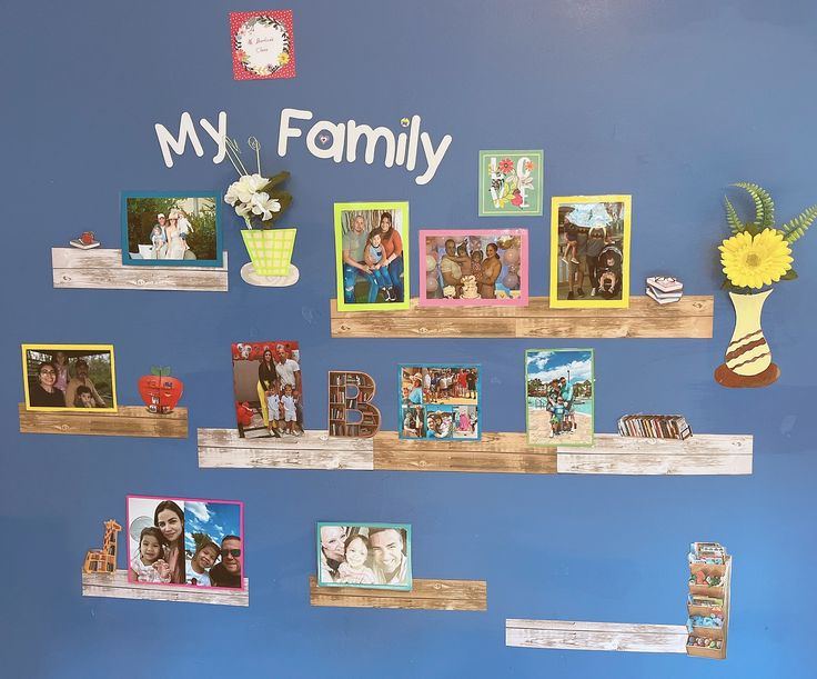 there are many pictures on the wall with family photos attached to each shelf and flowers in vases