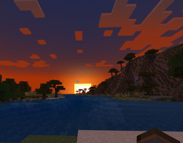 an image of a sunset in minecraft with the sun setting over water and trees