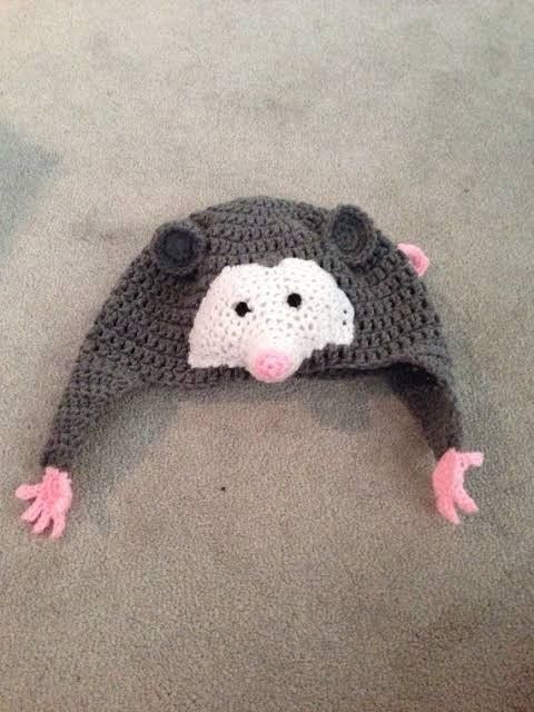 a crocheted hat with an animal's face on it sitting on the floor