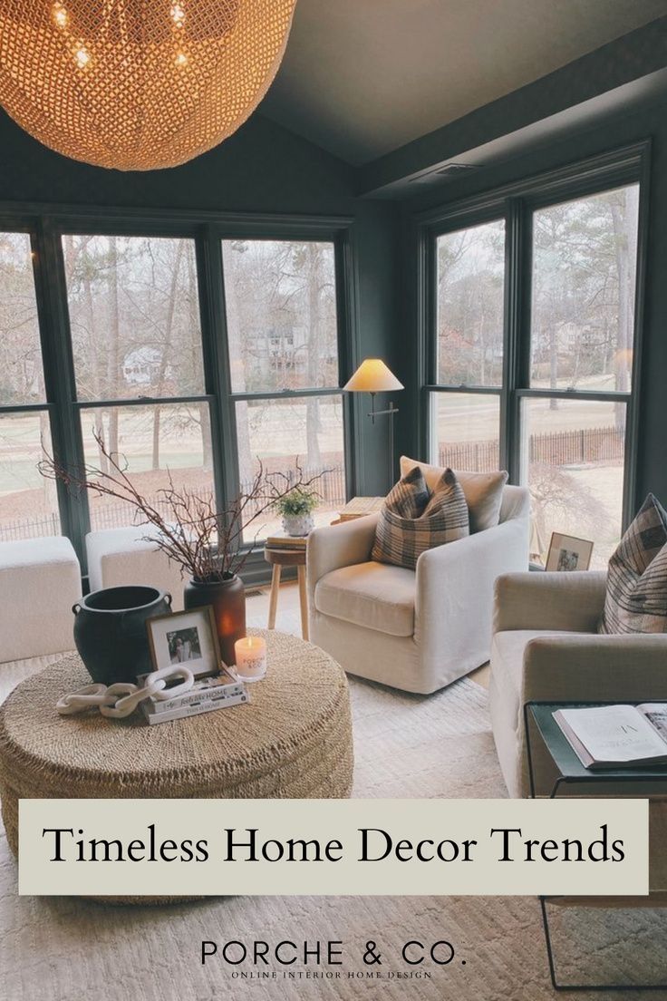 a living room filled with furniture and lots of windows next to a large chandelier