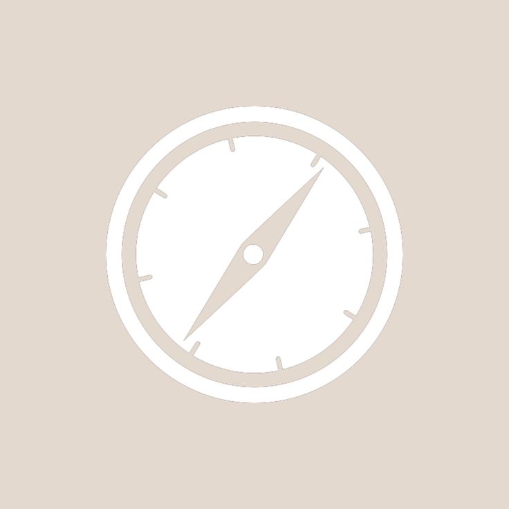 a white compass icon on a beige background