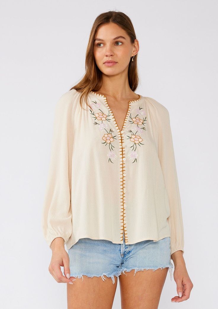 [Color: Natural/Pink] A front facing image of a brunette model wearing a cream colored bohemian blouse with floral embroidered details. With long raglan sleeves Spring Blouse, Blouse With Long Sleeves, Spring Blouses, Bell Design, Denim Short Dresses, Bohemian Tops, Boho Blouse, Embroidered Details, Tank Top Camisole