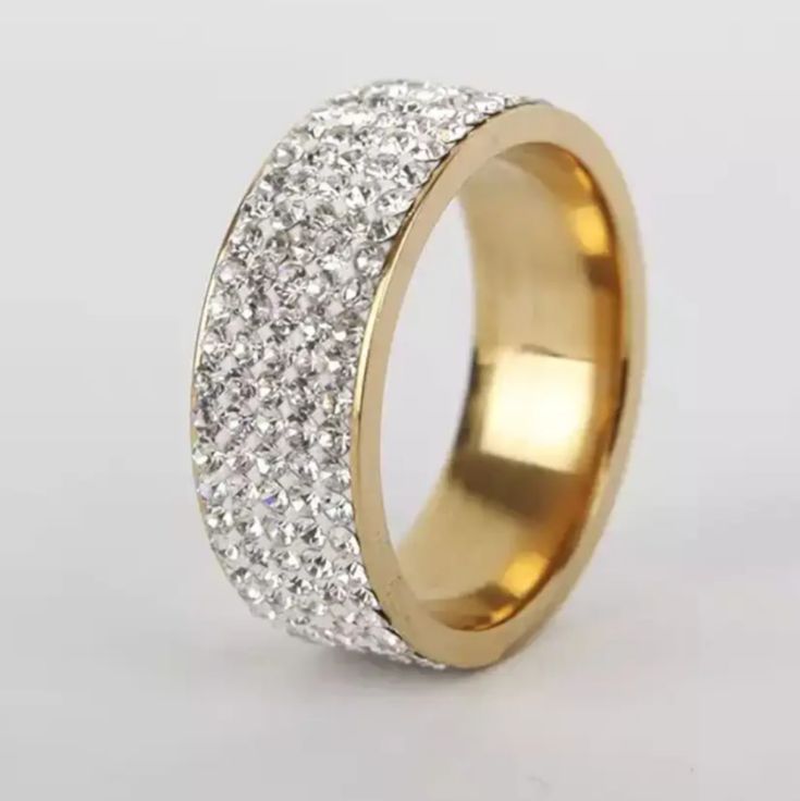 a gold ring with white diamonds on it