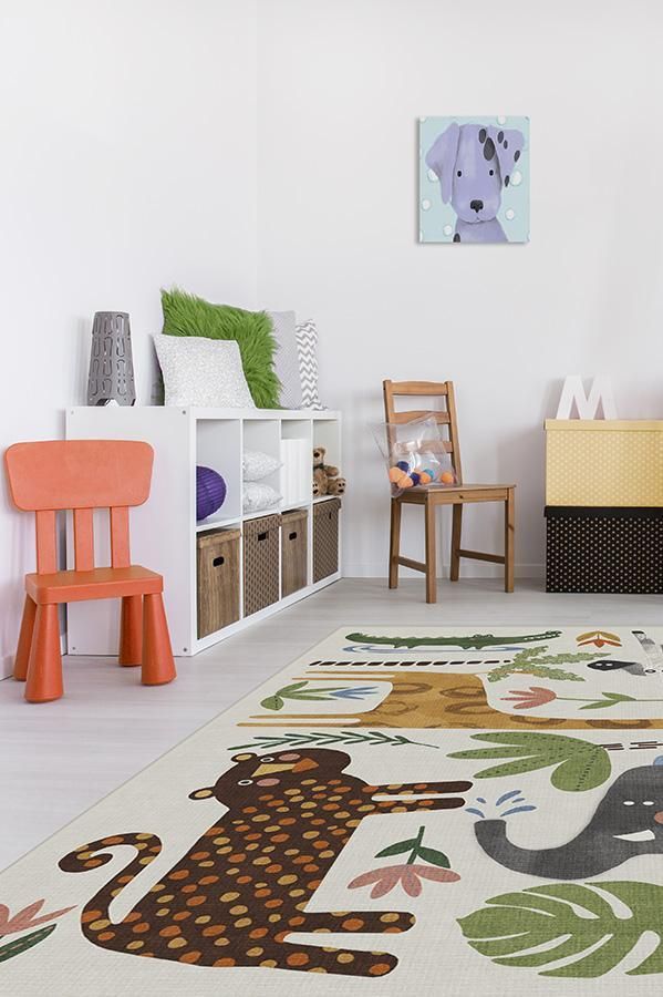 a child's playroom with various toys and decor on the walls, including an elephant rug