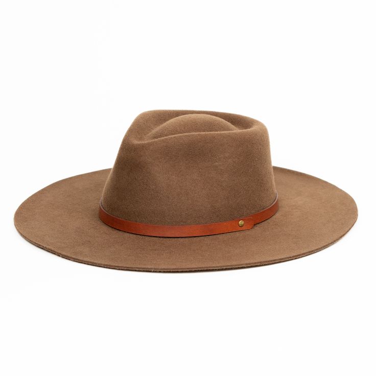 Our classic Rancher hat design, handmade from sheep's wool, is the perfect touch of sophistication. Wide-brimmed with a teardrop crown, and finished with a vegetable-tanned leather tie. Crafted with natural fibers makes for a versatile, all-season hat. We partner with a fourth generation family of hat-makers to highlight the traditional hat making process while adapting new, modern designs. Our hats are handmade and one-of-a-kind. This means that no two are exactly alike and almost all contain i Fall Fur Felt Panama Hat With Flat Brim, Winter Wool Wide Brim Panama Hat, Fall Fur Felt Boater Hat With Flat Brim, Classic Brown Hat With Flat Crown, Brown Fur Felt Hat With Flat Crown, Fur Felt Brimmed Boater Hat For Fall, Adjustable Wool Cloche Hat With Flat Brim, Adjustable Fur Felt Cloche Hat With Flat Brim, Fall Hats With Flat Crown