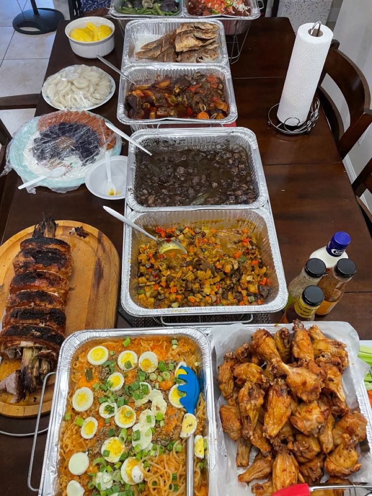 several trays of food sitting on top of a wooden table