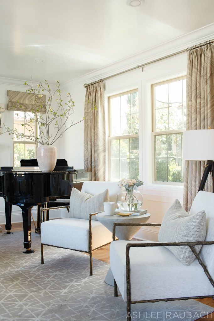 a living room filled with furniture and a piano