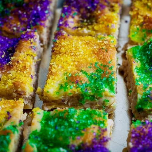 mardi gras desserts are lined up on a baking sheet and ready to be eaten