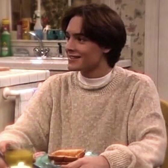 a man sitting at a table with food in front of him