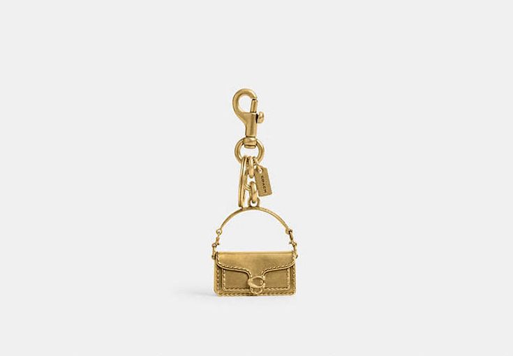 Tabby Bag Charm | COACH Elegant Everyday Bag Charm With Logo, Gold Bags With Logo Charm, Rectangular Bag Charm With Key Clip, Luxury Bags With Key Leash For Everyday Use, Rectangular Key Leash Bag Charm For Everyday, Rectangular Logo Bag Charm, Rectangular Bag Charm With Lobster Clasp For Everyday Use, Gold Keychain With Key Leash For Everyday Use, Luxury Keychain With Key Clip For Gift