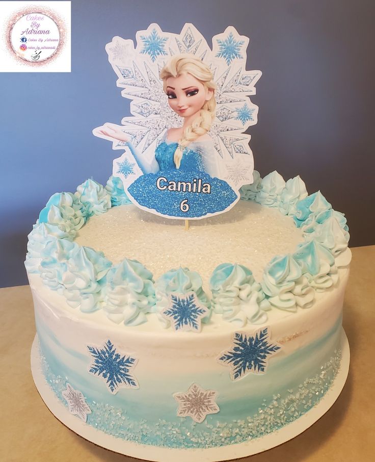 a frozen princess cake with frosting and icing on it's top is decorated with snowflakes