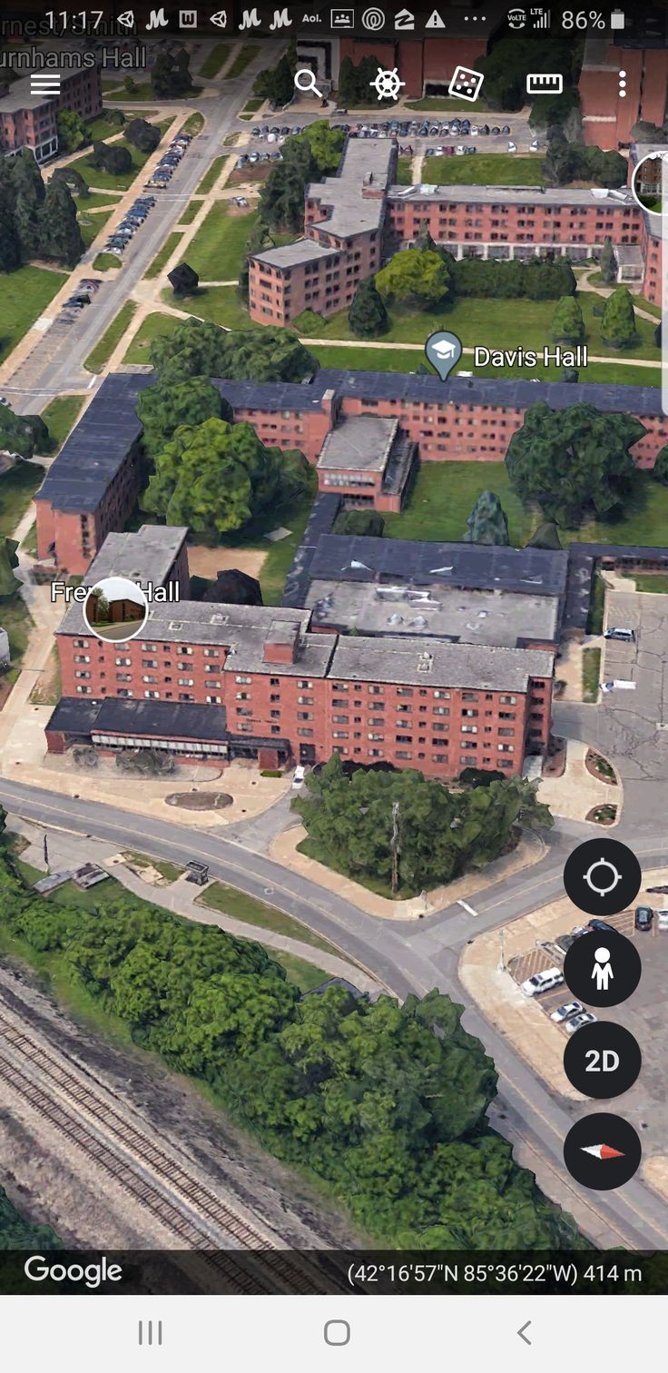 an aerial view of a building and train tracks