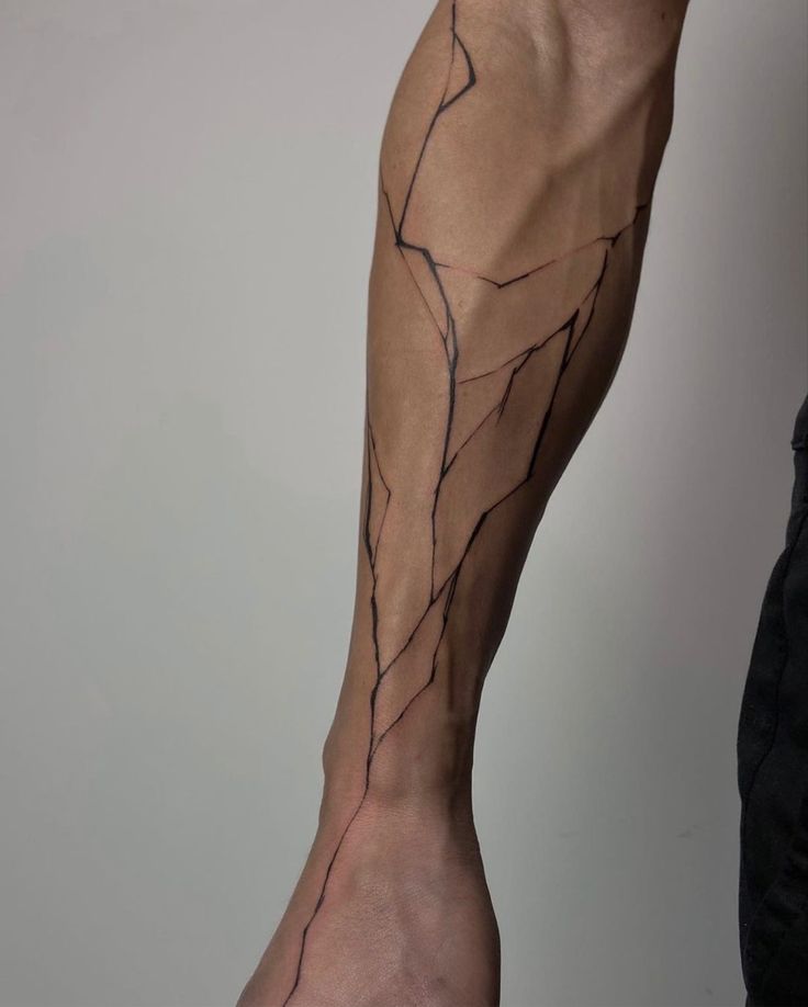 a man's arm with a vine tattoo on the left side of his leg