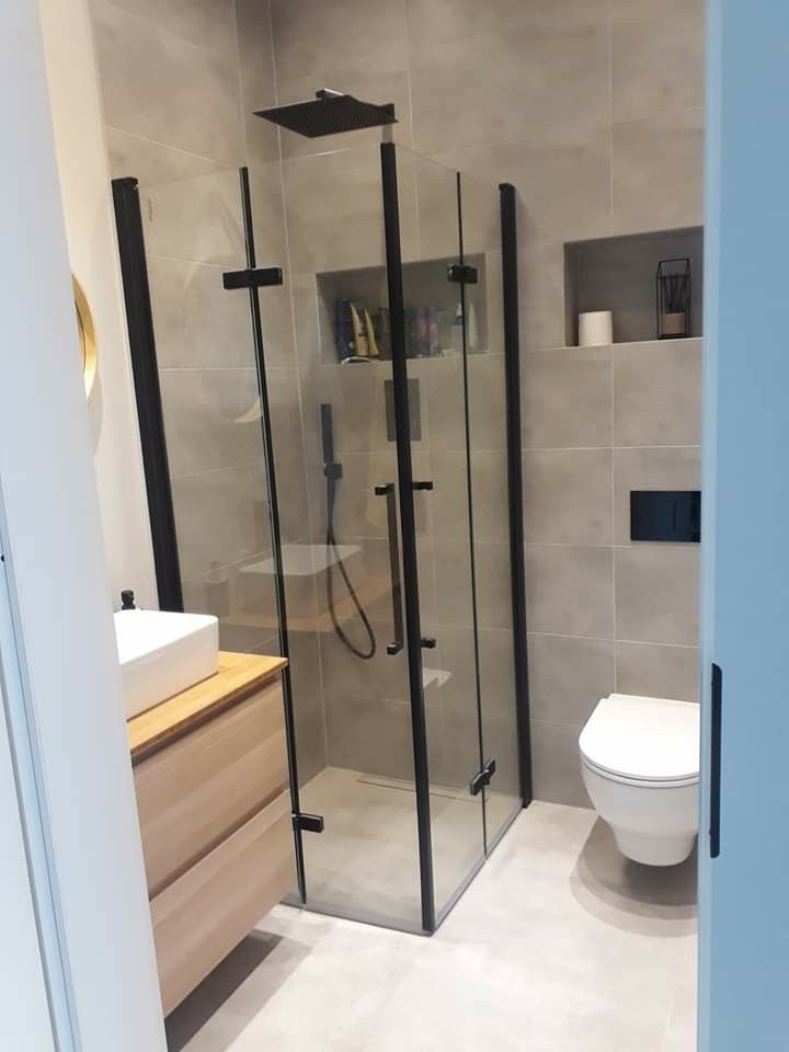 a bathroom with a walk in shower next to a toilet