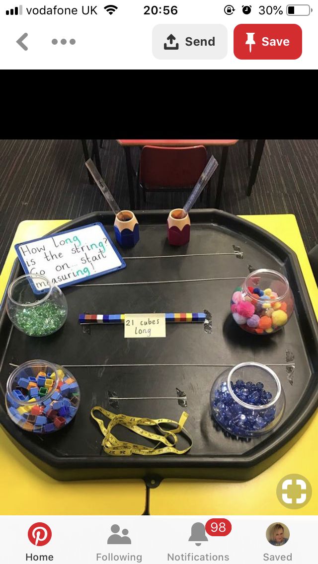 the table has many items on it and is decorated with markers, pencils, beads and pens