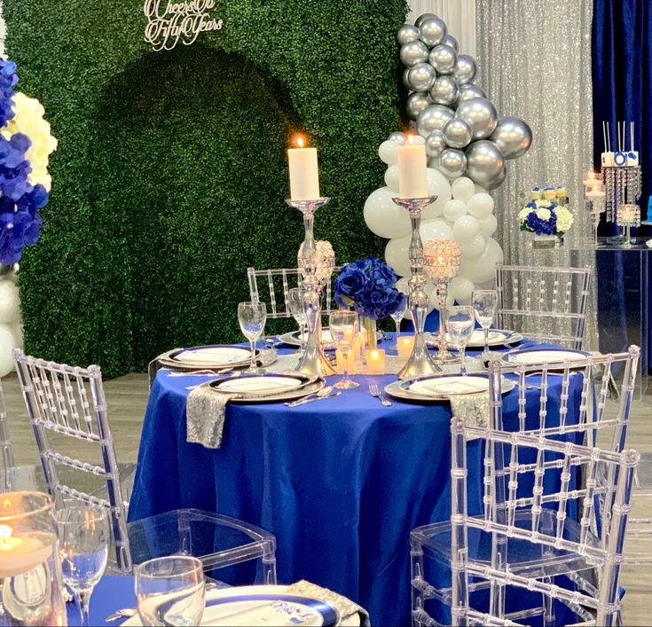 a table set up with blue and white decorations