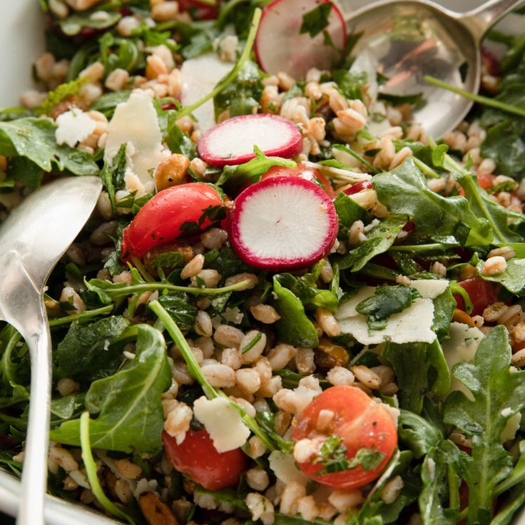 a salad with radishes, spinach, and other veggies in it