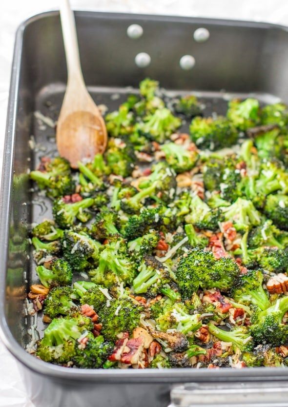 broccoli and bacon casserole in a pan with a wooden spoon