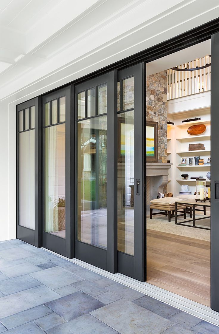 an open glass door leading into a living room