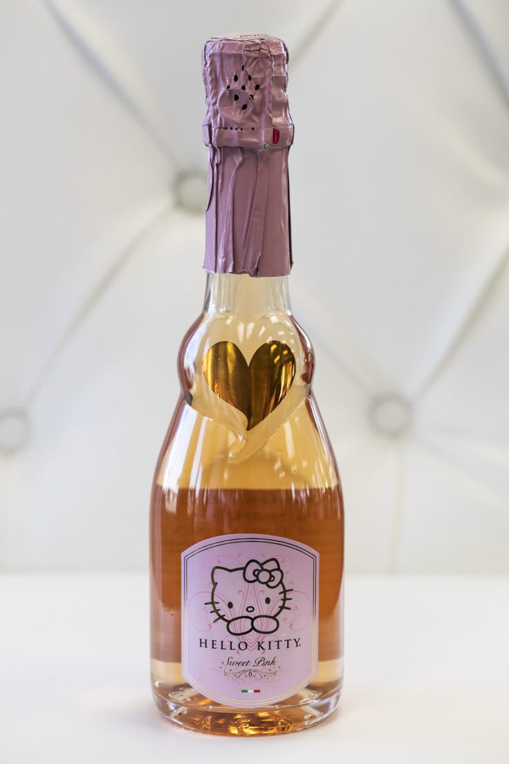 a bottle of hello kitty wine with a heart on the top and label that says hello kitty