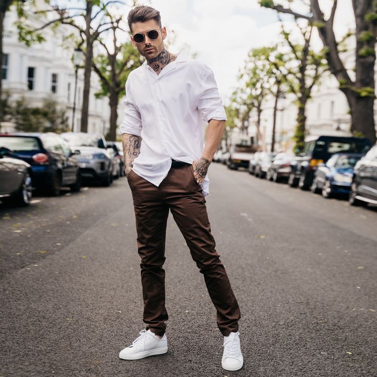 "Looking for the perfect trousers to take your style up a notch? Our slim fit chinos are just what you need. Made from brown twill fabric, they have a slim fit that's stretched for comfort and a dapper look. Plus, the button and zip fly fastening make them ideal for both business and casual looks. And with five pockets, you'll have plenty of room to carry all your essentials. If you're looking to create a dapper look, pair these brown slim fit chinos trousers with long shirts. Brown twill fabric Slim fit Button and zip fly fastening 5-pocket design Fabric: 98% Cotton, 2% Elastane Model is 6'1\" and Wears Size 32 FIND YOUR SIZE and check our size guide to find your perfect fit. Size = 30 - 40 Waist = 80cm - 104cm Hip = 100cm - 124cm Inside Leg = 81cm Waist is measured All Around. Hip is mea Casual Brown Slim Fit Dress Pants, Brown Tapered Leg Chinos For Business Casual, Brown Casual Chinos For Business Casual, Brown Cotton Chinos For Workwear, Brown Tapered Leg Chinos For Work, Casual Brown Chino Cotton Twill Chinos, Casual Brown Cotton Dress Pants, Business Casual Brown Straight Leg Chinos, Business Casual Brown Cotton Dress Pants