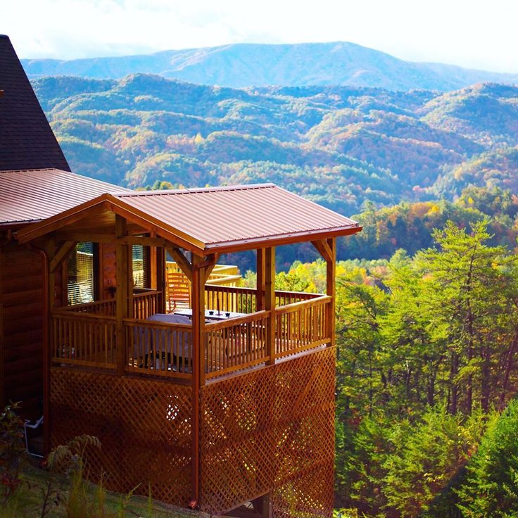 a view of the mountains and trees from a cabin