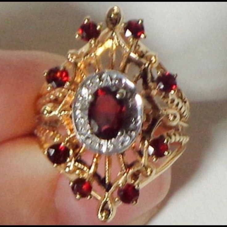 Vintage Victorian Filigree Garnet And Diamond Ring! Authentic Antique! This Is A Gorgeous, Vintage, 14k Solid Yellow Gold Filigree, Art Nouveau Design Ring, Is In A Marquise Shape, With A 4mm X 6mm Oval Cut Garnet In The Center, With A Diamond Halo. There Are Also Eight 2mm Round Cut Garnets In The Filigree, Marquise Shape Design. The Total Weight Of This Stunning Size 6 1/4 Ring Is 6.3 Grams. The Face Measures 25mm North To South. And The Ring Is Not Resizable. The Eight Diamonds Are Genuine, With A Total Carat Weight Of Approx. 0.04, H-I Color, And Si-I Clarity, All Prong Set. The Genuine Garnets, 9 In Total, Have A Carat Weight Of 0.90. In Pristine Condition, This Antique Piec Gold Filigree Ruby Ring For Anniversary, Gold Ruby Ring With Filigree For Anniversary, Anniversary Gold Ruby Ring With Filigree, Ornate 14k Gold Ruby Ring For Anniversary, Victorian Yellow Gold Jewelry With Accent Stones, Ornate Yellow Gold Ruby Ring Gift, Oval Filigree Ring With 17 Jewels For Anniversary, Anniversary Ruby Ring In Yellow Gold With Intricate Design, Anniversary Yellow Gold Ruby Ring With Intricate Design