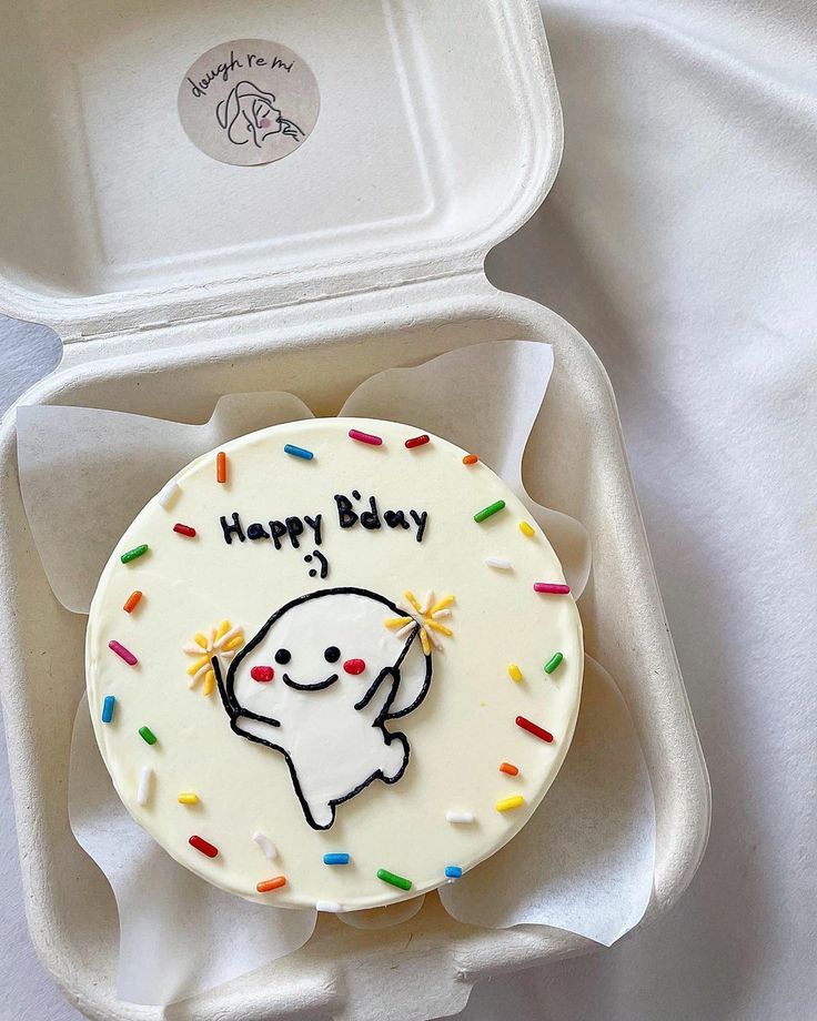 a happy birthday cake in a white box with sprinkles on the inside