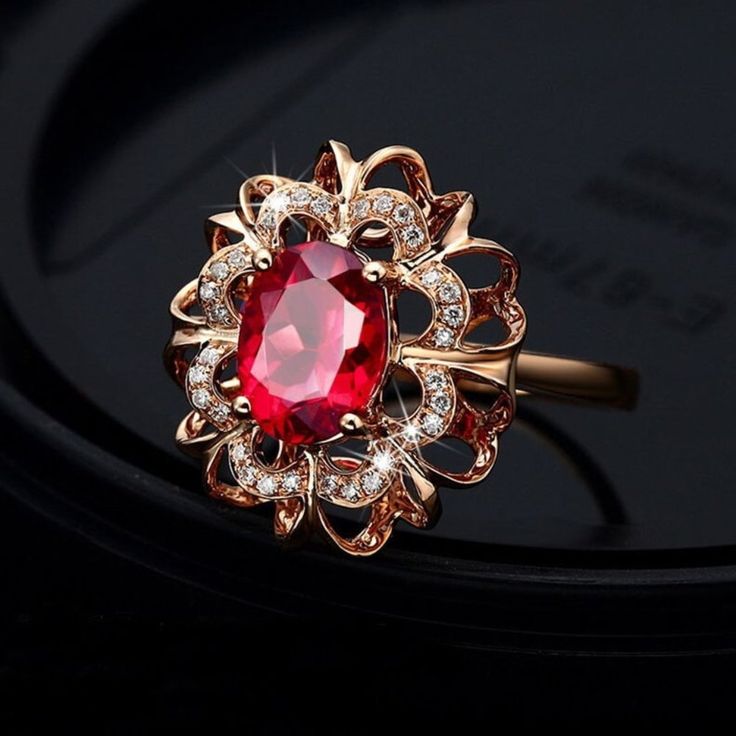 Brand New Ring Made Out Of Rose Gold Plated 925 Sterling Silver With An Oval Shaped Created Ruby Set In The Center In A Halo Shaped Design. The Halo Is 5/8" X 3/16" Large And The Center Stone Is 3/16" X 5/16" Large. The Ring Weighs 6 Grams. R0489-94 Large Ruby Ring, Gold Elegant Jewelry, Gold Ruby Jewelry, Oval Ruby Ring Design, Women Rings Gold Design, Gem Rings Stones, Ruby Ring Designs Unique, Wedding Rings Ruby, Gold Diamond Rings For Women