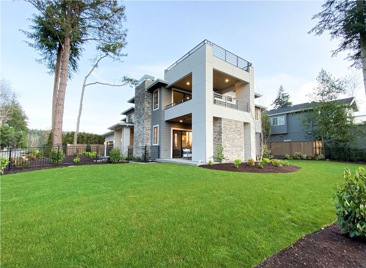 a large house sitting on top of a lush green field